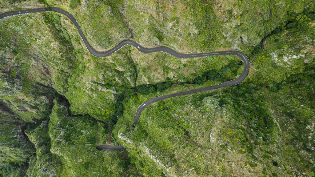 drone top view bended road on mountain of Paul do Mar, Madeira island, Portugal
